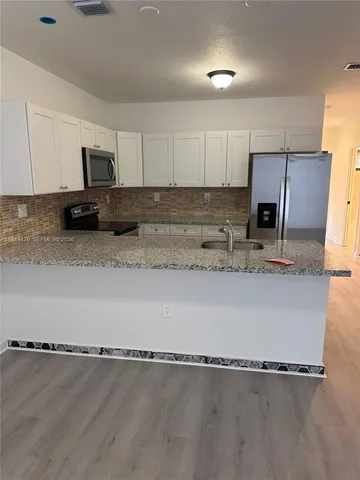 a view of an empty room and wooden floor