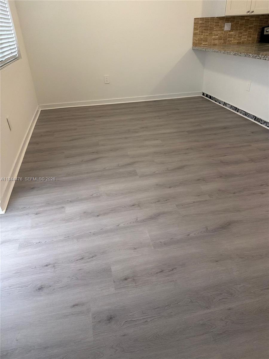 13390 Southwest 251st Terrace, Unit 1 Homestead, FL 33032 - Photo 21 of 22 a view of an empty room and wooden floor