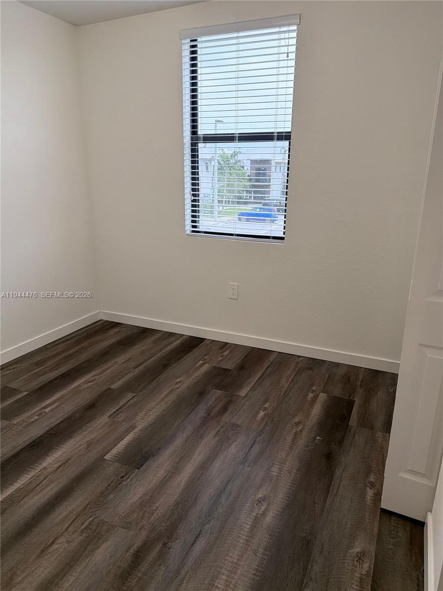 13390 Southwest 251st Terrace, Unit 1 Homestead, FL 33032 - Photo 22 of 22 an empty room with a window