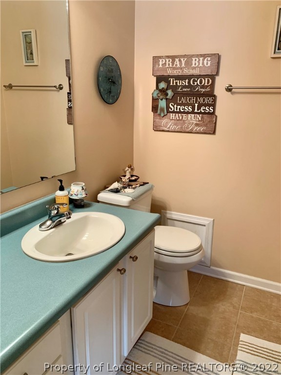 4481 Virsalli Loop Hope Mills, NC 28348 - Photo 11 of 24 a bathroom with a toilet a sink and a mirror