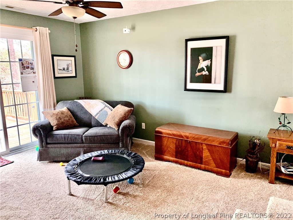 4481 Virsalli Loop Hope Mills, NC 28348 - Photo 14 of 24 a living room with furniture a rug and a window