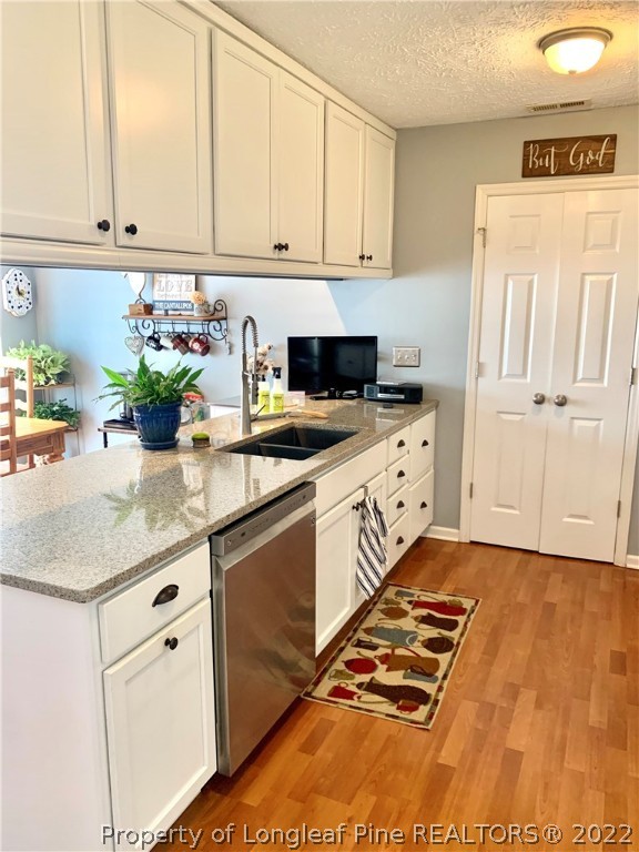 4481 Virsalli Loop Hope Mills, NC 28348 - Photo 4 of 24 a kitchen with stainless steel appliances granite countertop a stove a sink and a white cabinets