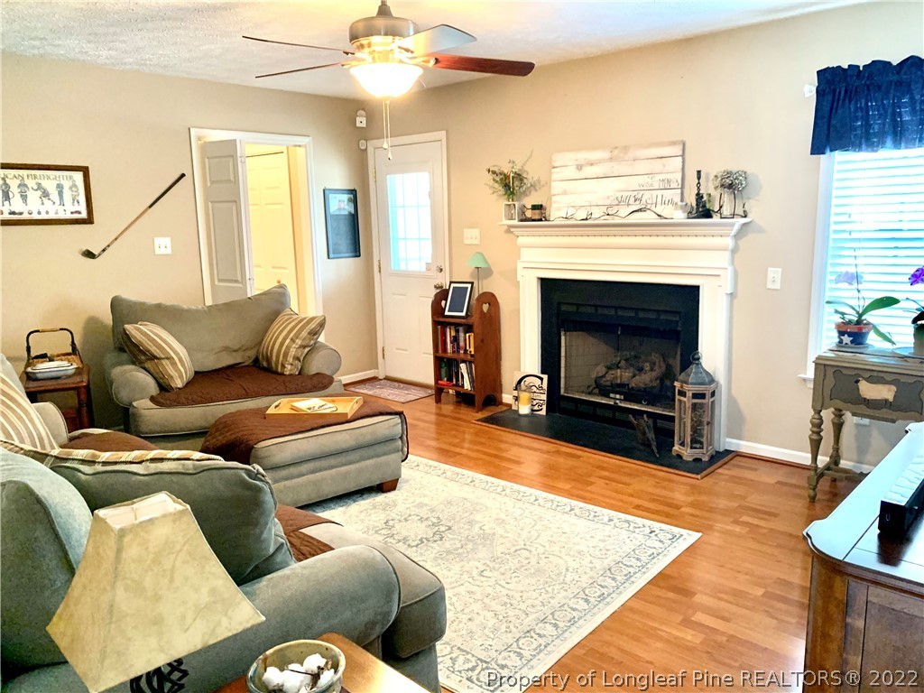 4481 Virsalli Loop Hope Mills, NC 28348 - Photo 6 of 24 a living room with furniture and a fireplace