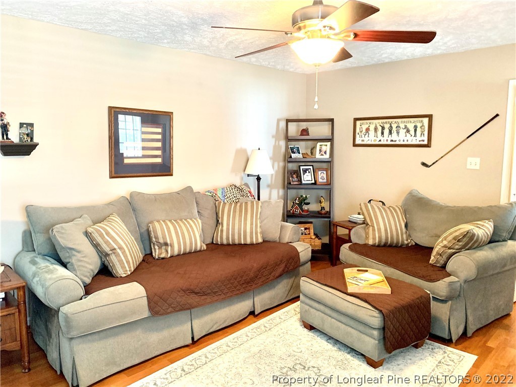 4481 Virsalli Loop Hope Mills, NC 28348 - Photo 7 of 24 a living room with furniture and a flat screen tv