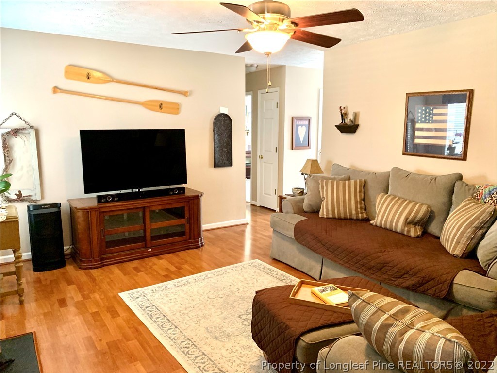4481 Virsalli Loop Hope Mills, NC 28348 - Photo 8 of 24 a living room with furniture and a flat screen tv