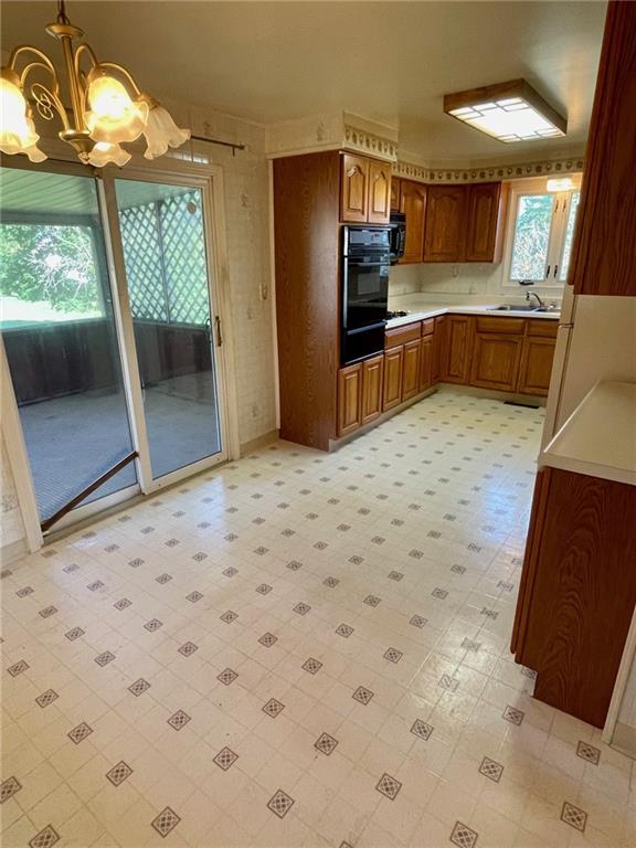 445 Tevebaugh Hollow Road Freedom, PA 15042 - Photo 5 of 17 a kitchen with granite countertop a refrigerator and a sink