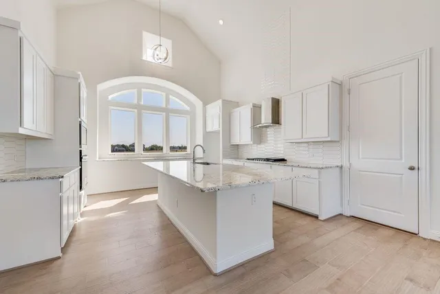a kitchen with stainless steel appliances granite countertop a sink and cabinets