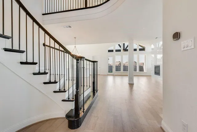 a view of entryway and hall with wooden floor