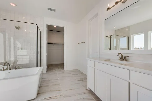 a bathroom with a double vanity sink mirror and shower