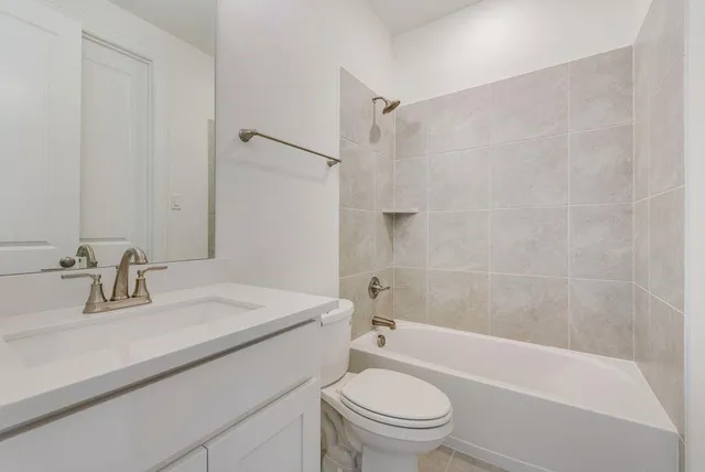 a view of a hallway with wooden floor and windows