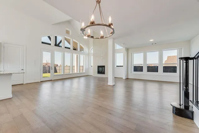 a view of a livingroom with furniture wooden floor and windows