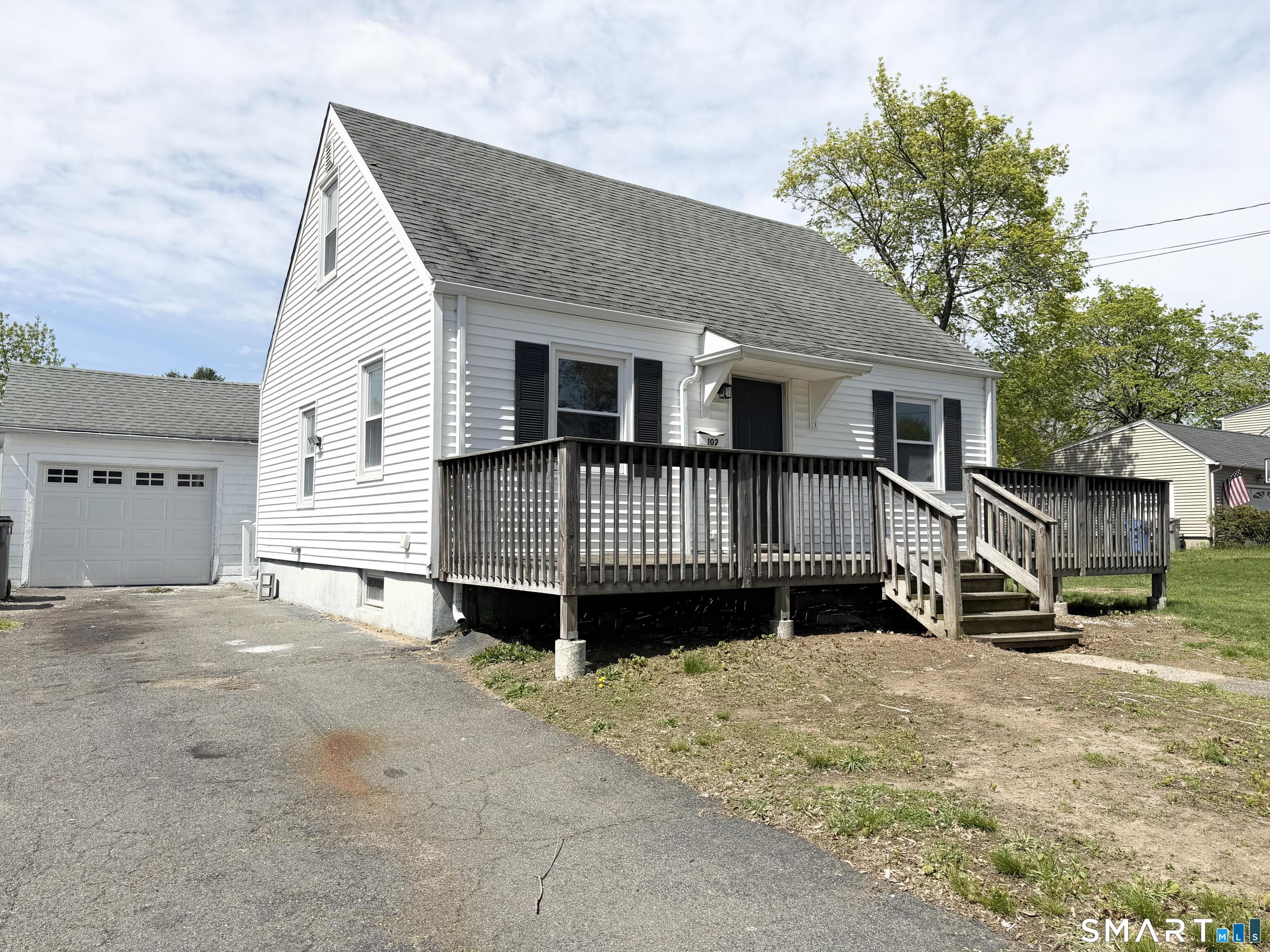 a view of a house with wooden deck front of house