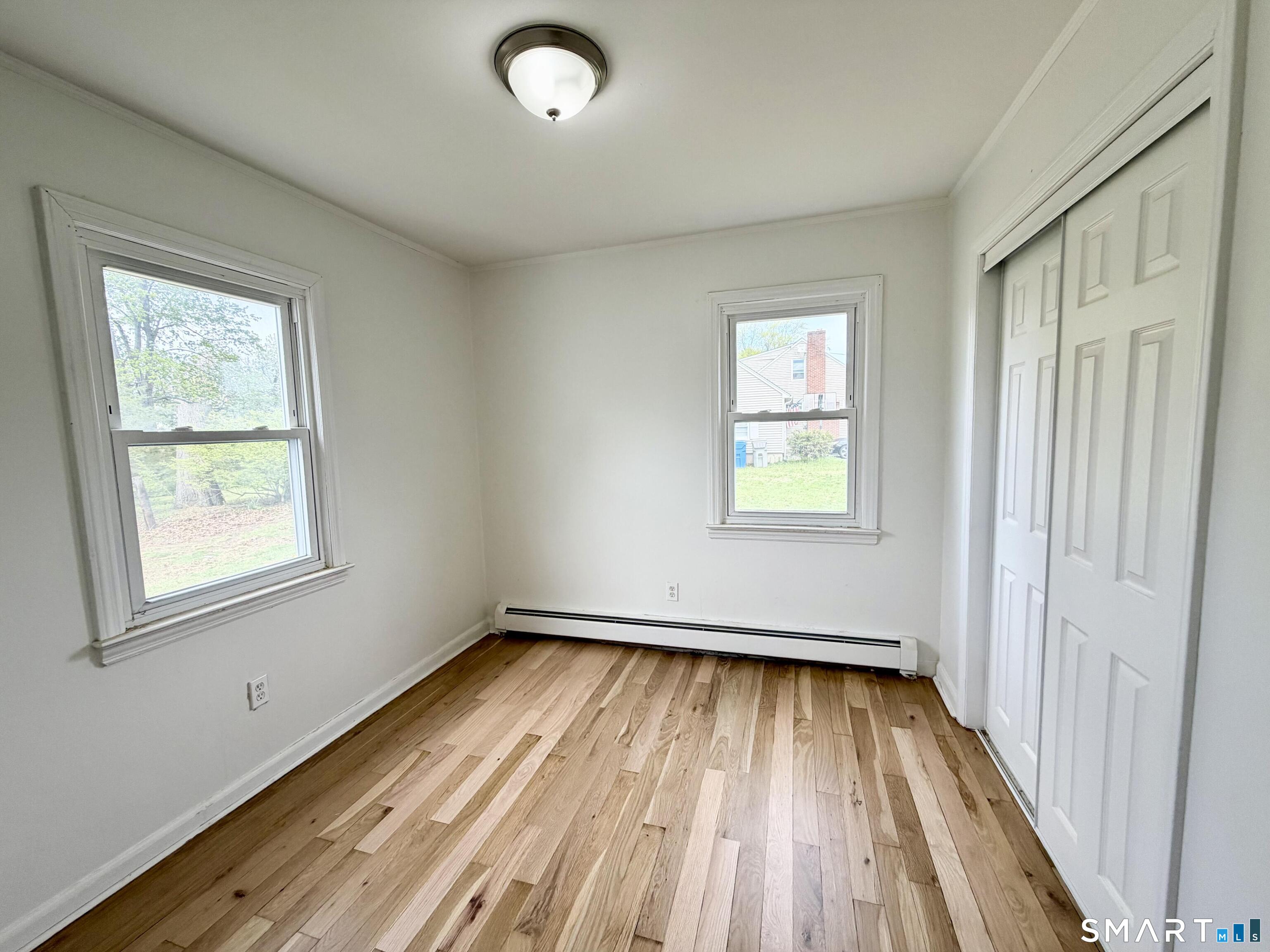 102 Benham Street Bristol, CT 06010 - Photo 14 of 17 wooden floor in an empty room with a window