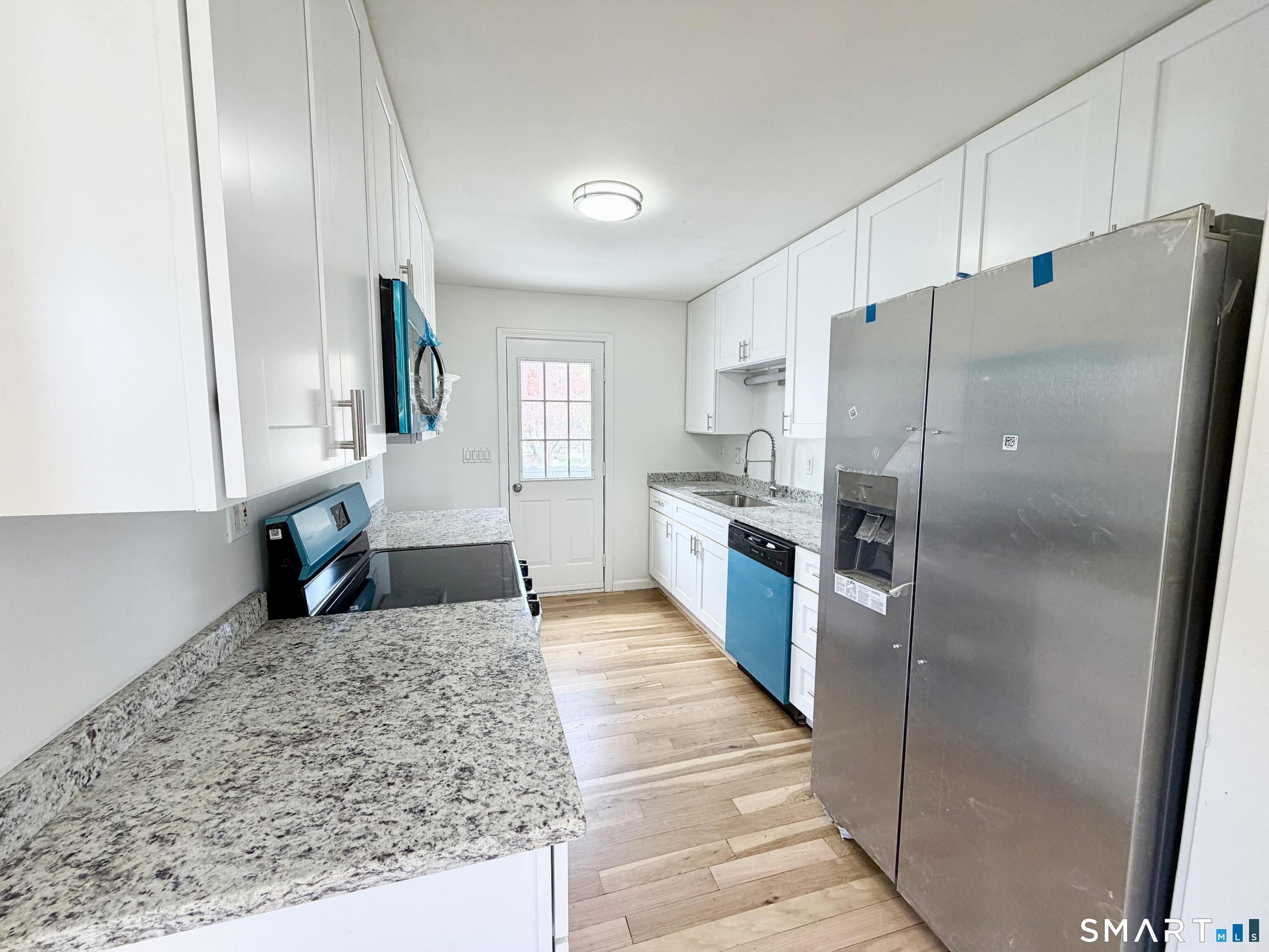 102 Benham Street Bristol, CT 06010 - Photo 5 of 17 a kitchen with stainless steel appliances granite countertop a refrigerator a oven and a sink