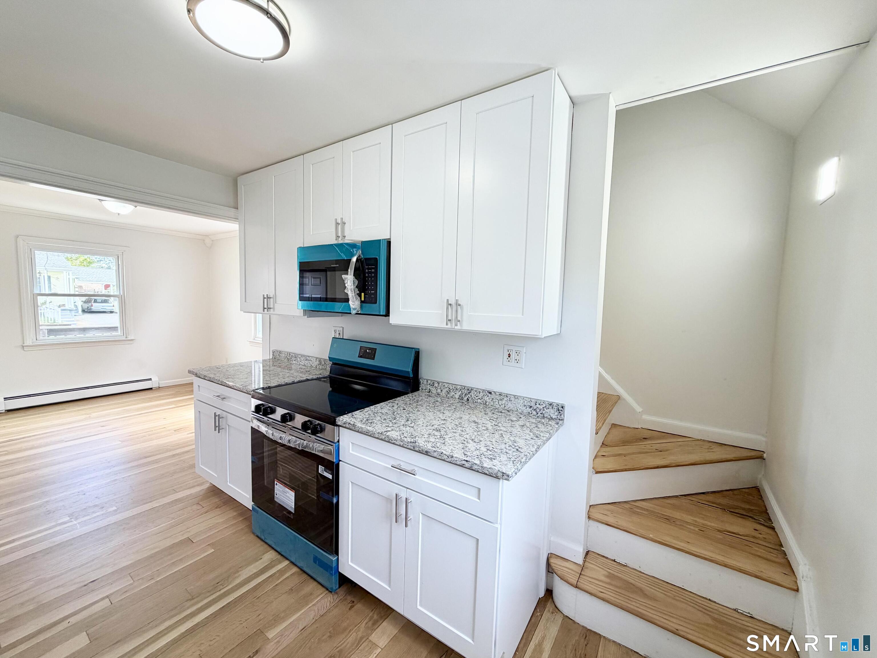 102 Benham Street Bristol, CT 06010 - Photo 7 of 17 a kitchen with granite countertop a stove and a sink