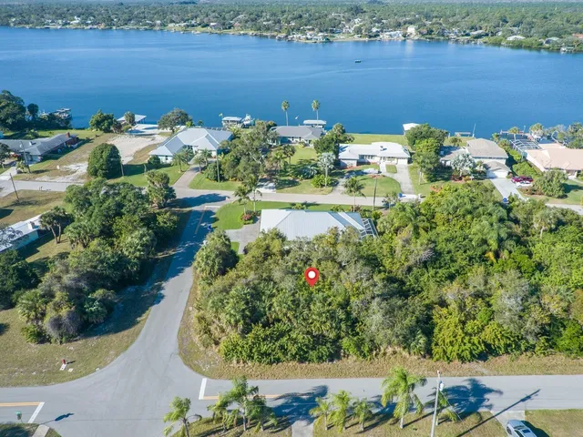 an aerial view of a houses with a lake view