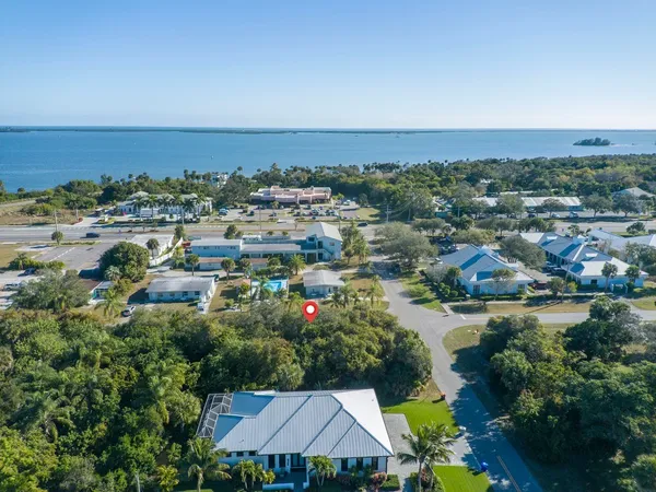 an aerial view of a houses with a lake view