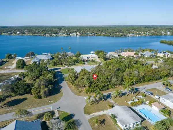 an aerial view of a house with a lake view