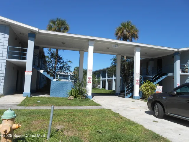 a view of a house with backyard porch and sitting area