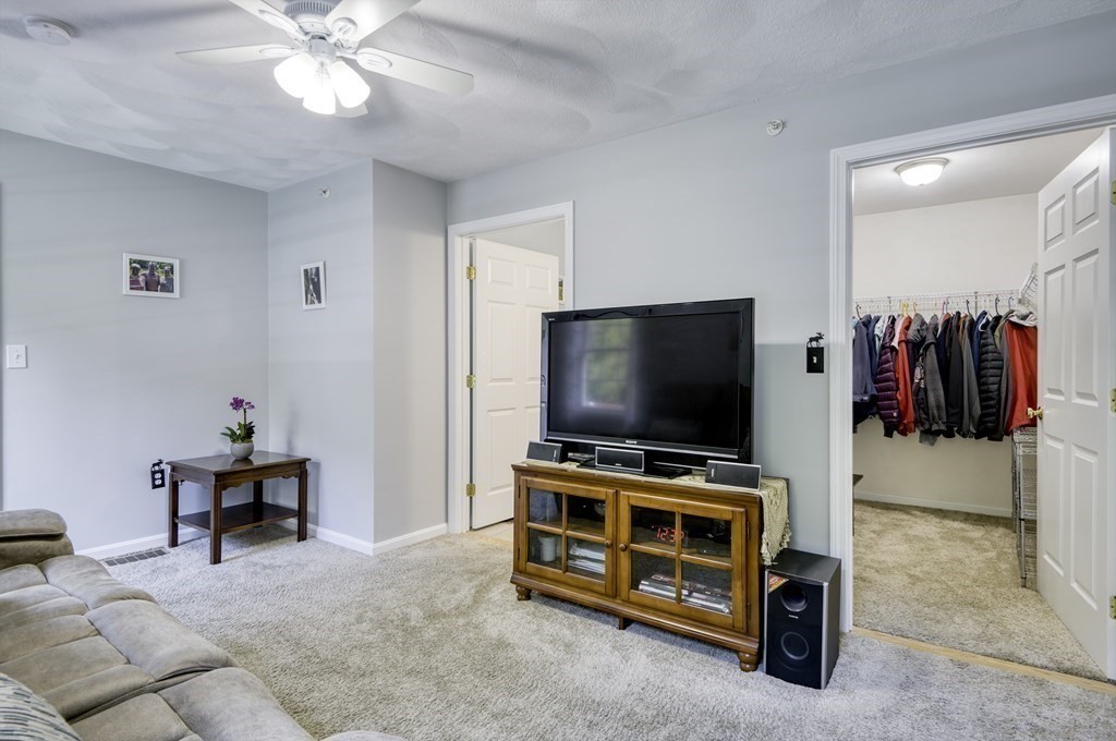 159 Allen Road, Unit 24 Billerica, MA 01821 - Photo 11 of 34 a room with furniture and flat screen tv