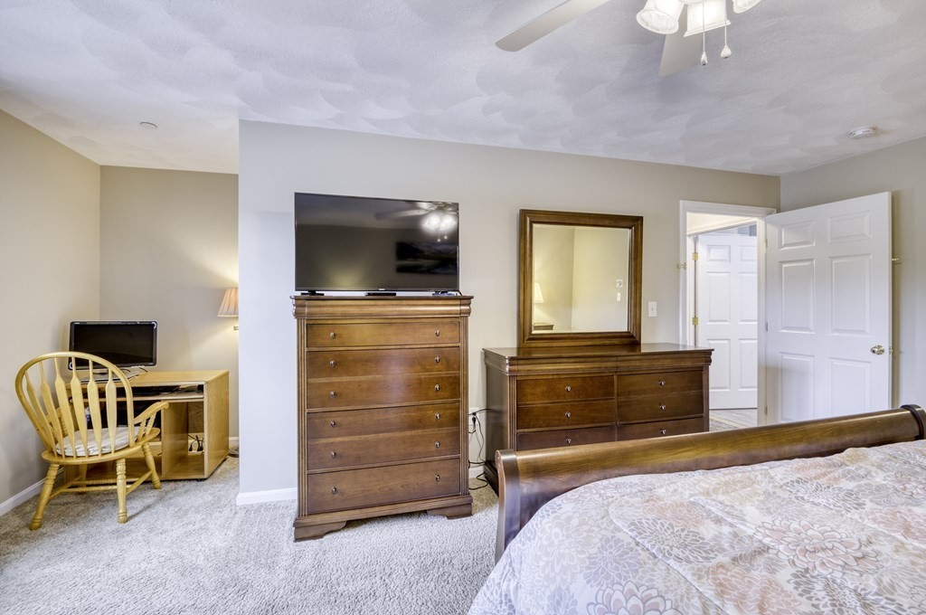 159 Allen Road, Unit 24 Billerica, MA 01821 - Photo 16 of 34 a bedroom with a bed and a television