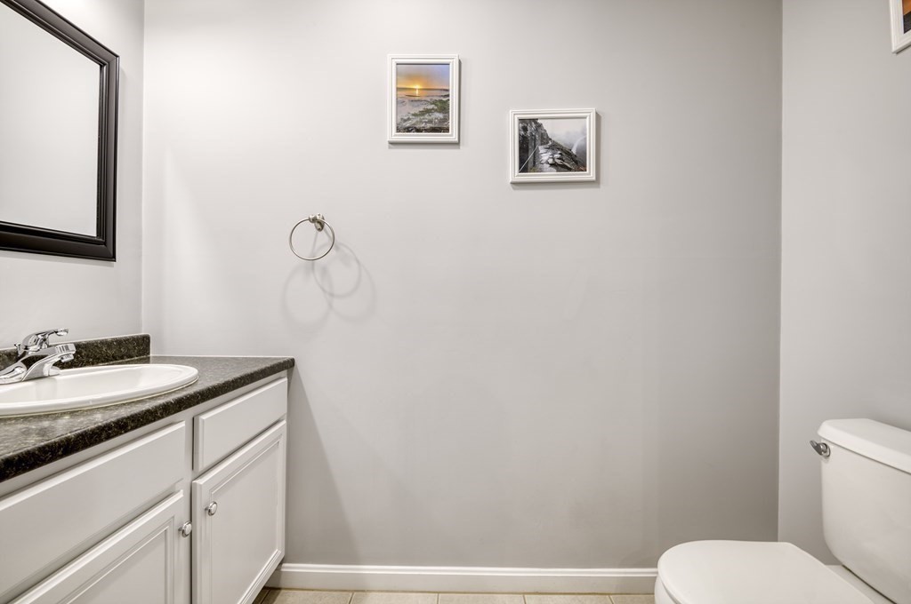 159 Allen Road, Unit 24 Billerica, MA 01821 - Photo 9 of 34 a bathroom with a granite countertop sink mirror vanity and toilet