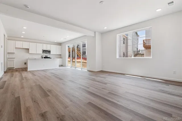a view of kitchen with wooden floor and electronic appliances