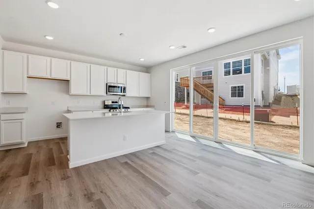 a kitchen with stainless steel appliances granite countertop a sink and cabinets