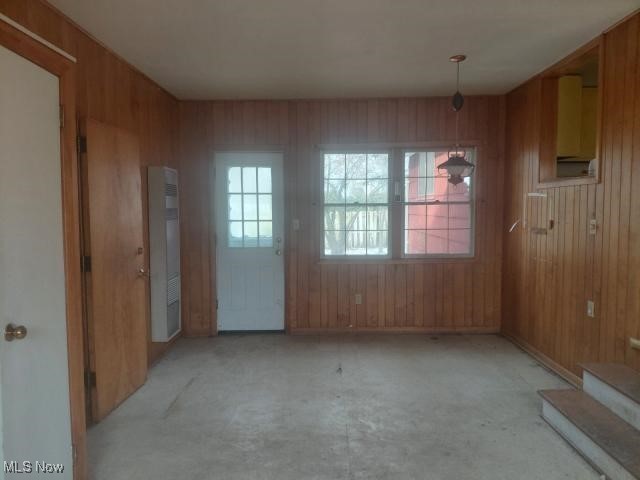 14849 Whitney Road Strongsville, OH 44136 - Photo 4 of 16 Unfurnished dining area with wood walls and a heating unit
