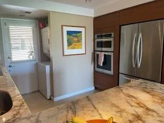 a bedroom with a bed and a refrigerator