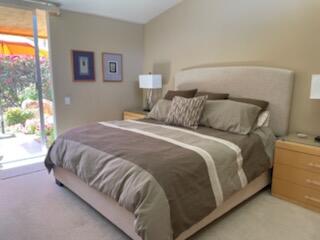 73446 Dalea Lane Palm Desert, CA 92260 - Photo 5 of 17 a large bed sitting in a bedroom next to a window