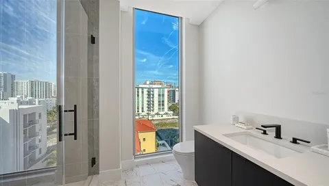a living room with furniture and a floor to ceiling window