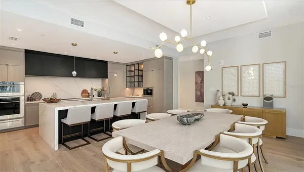 a view of kitchen with sink dining table and chairs