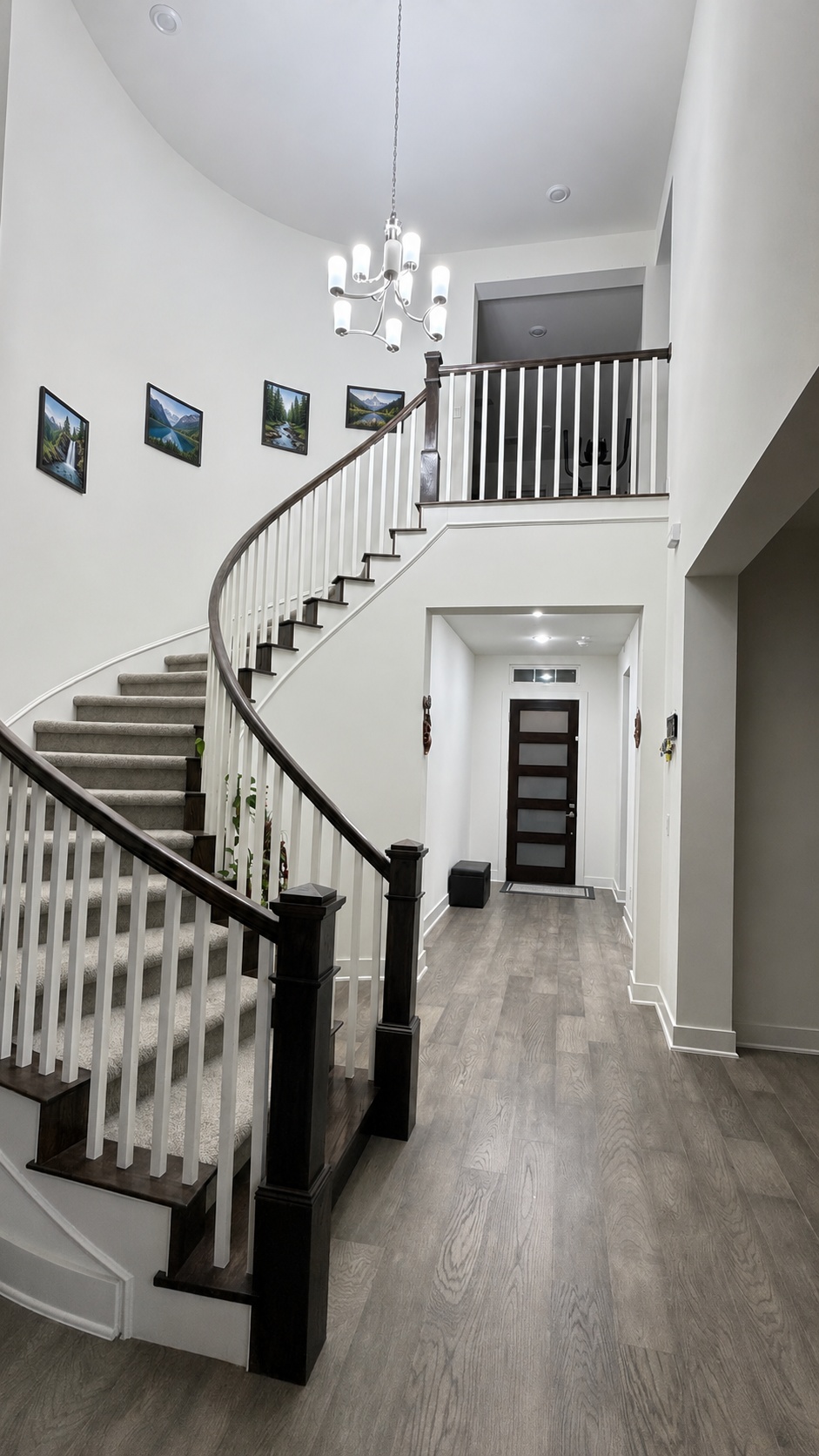 7290 Shoshoni Loop Round Rock, TX 78681 - Photo 3 of 6 A grand, curved staircase with high ceilings defines this welcoming entry, setting a tone of modern elegance.