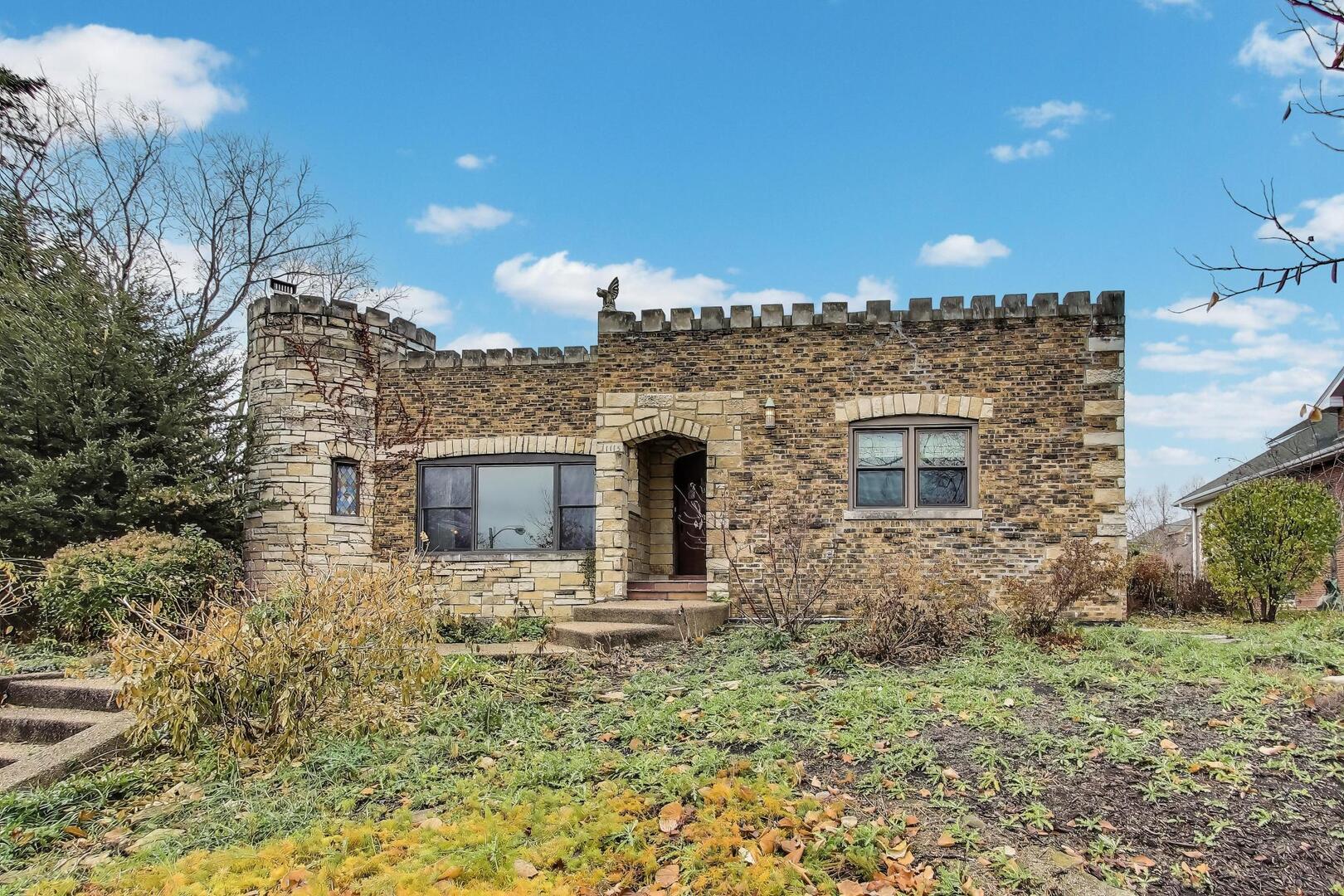 a front view of a house with plants