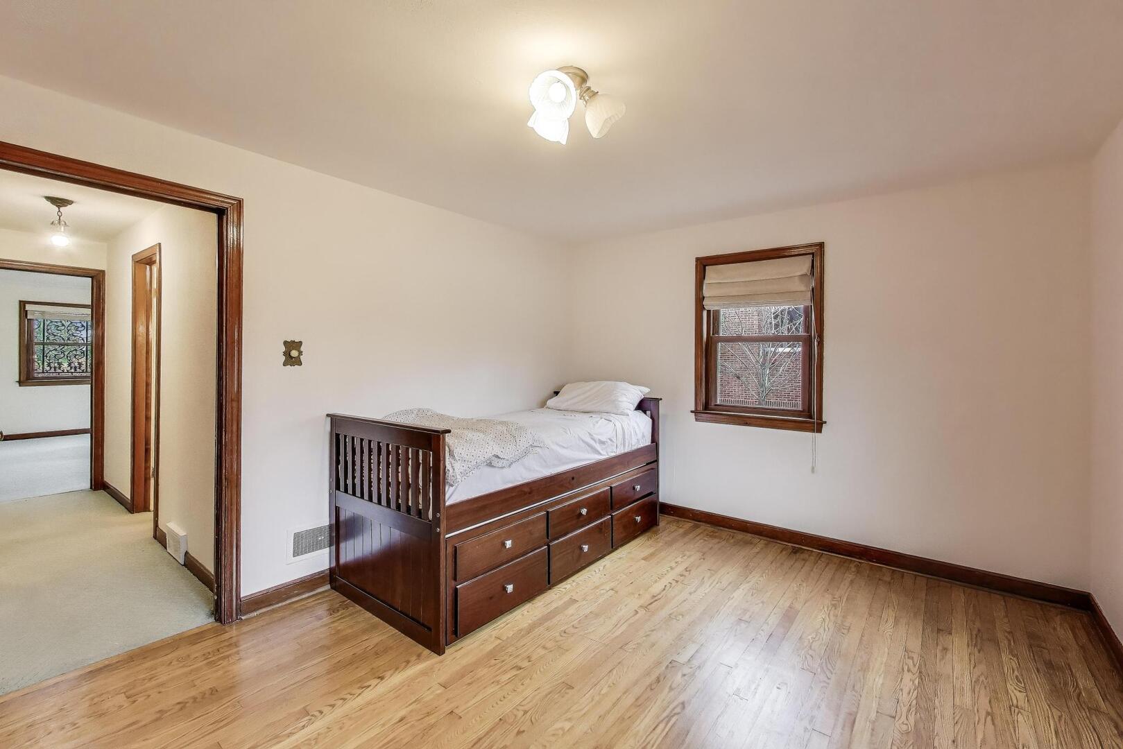 1115 North Ridgeland Avenue Oak Park, IL 60302 - Photo 18 of 40 a room with a bed and wooden floor