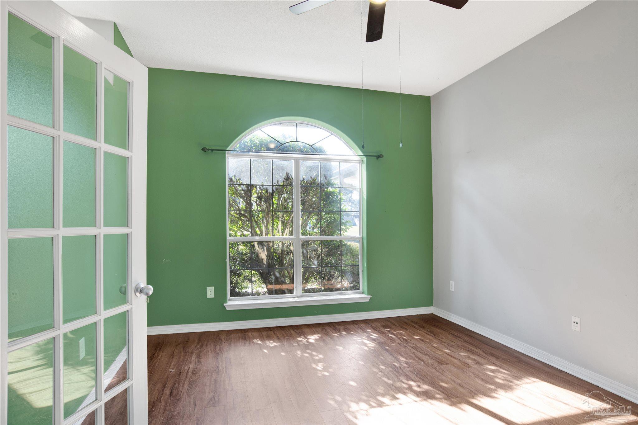 7604 Brewster Street Navarre, FL 32566 - Photo 13 of 36 a view of a room that has a large window