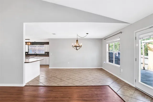 a view of a kitchen with wooden floor and a window