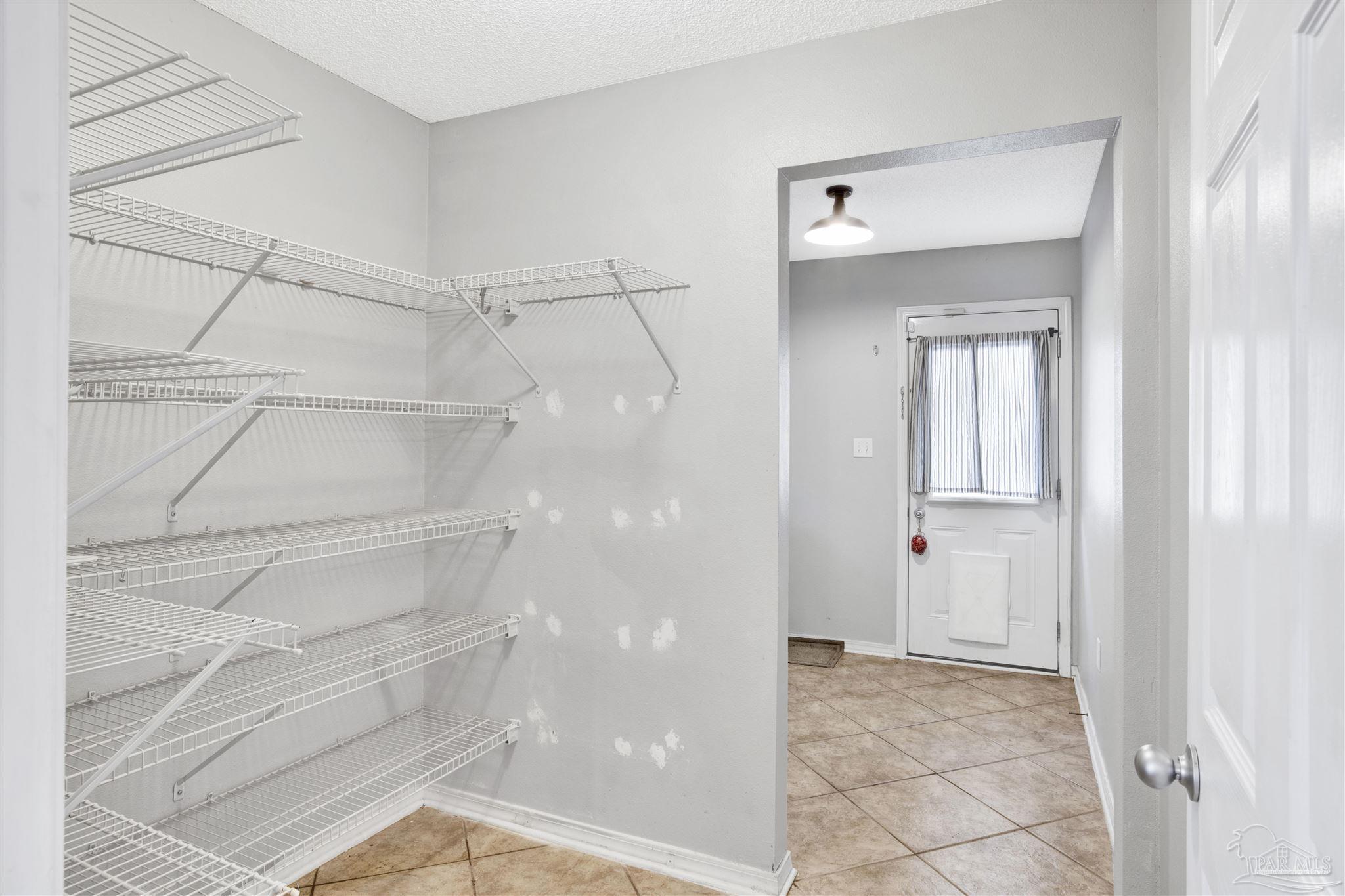 7604 Brewster Street Navarre, FL 32566 - Photo 23 of 36 a view of an empty walk in closet
