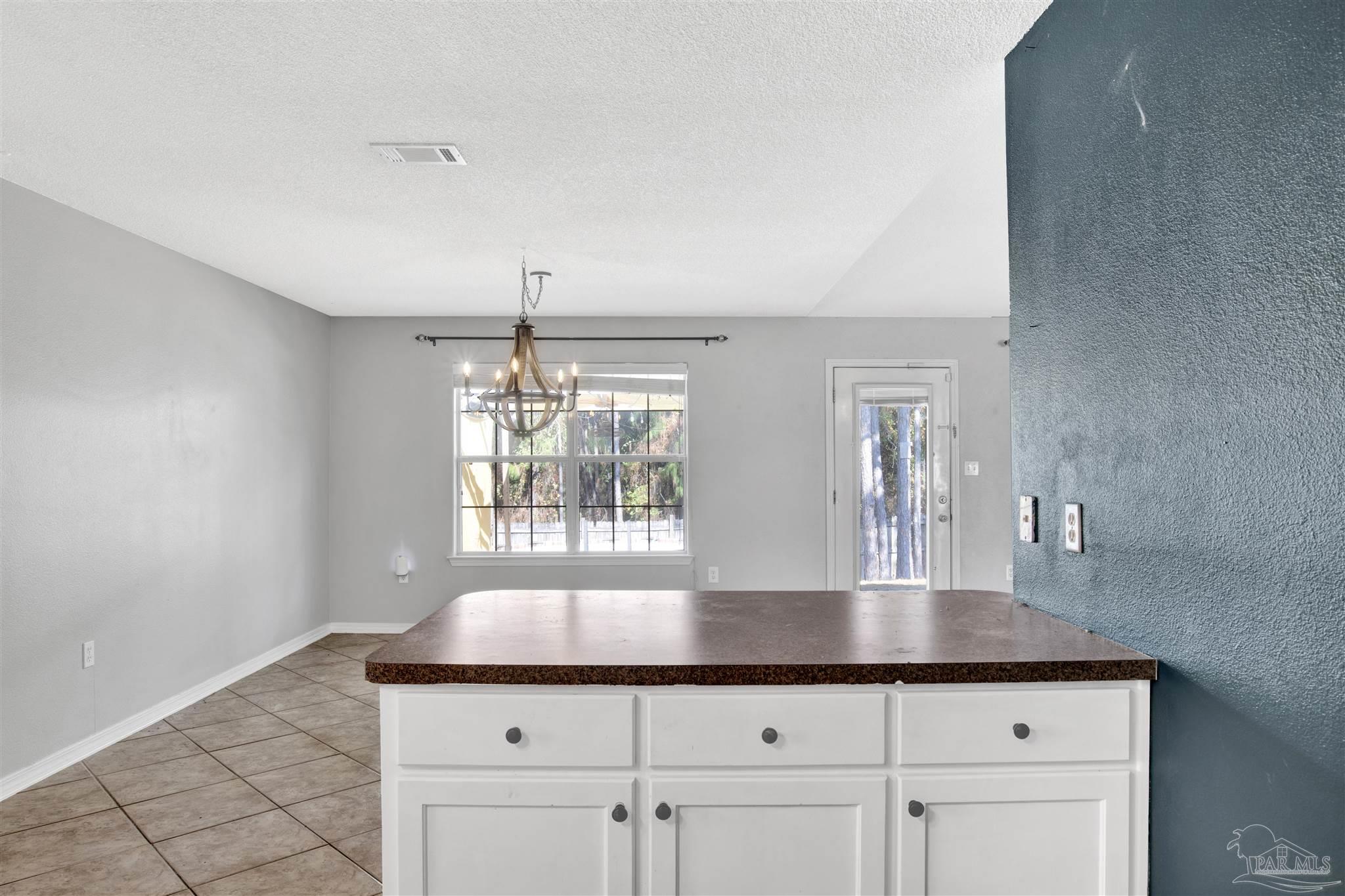 7604 Brewster Street Navarre, FL 32566 - Photo 26 of 36 a kitchen with a cabinets and window