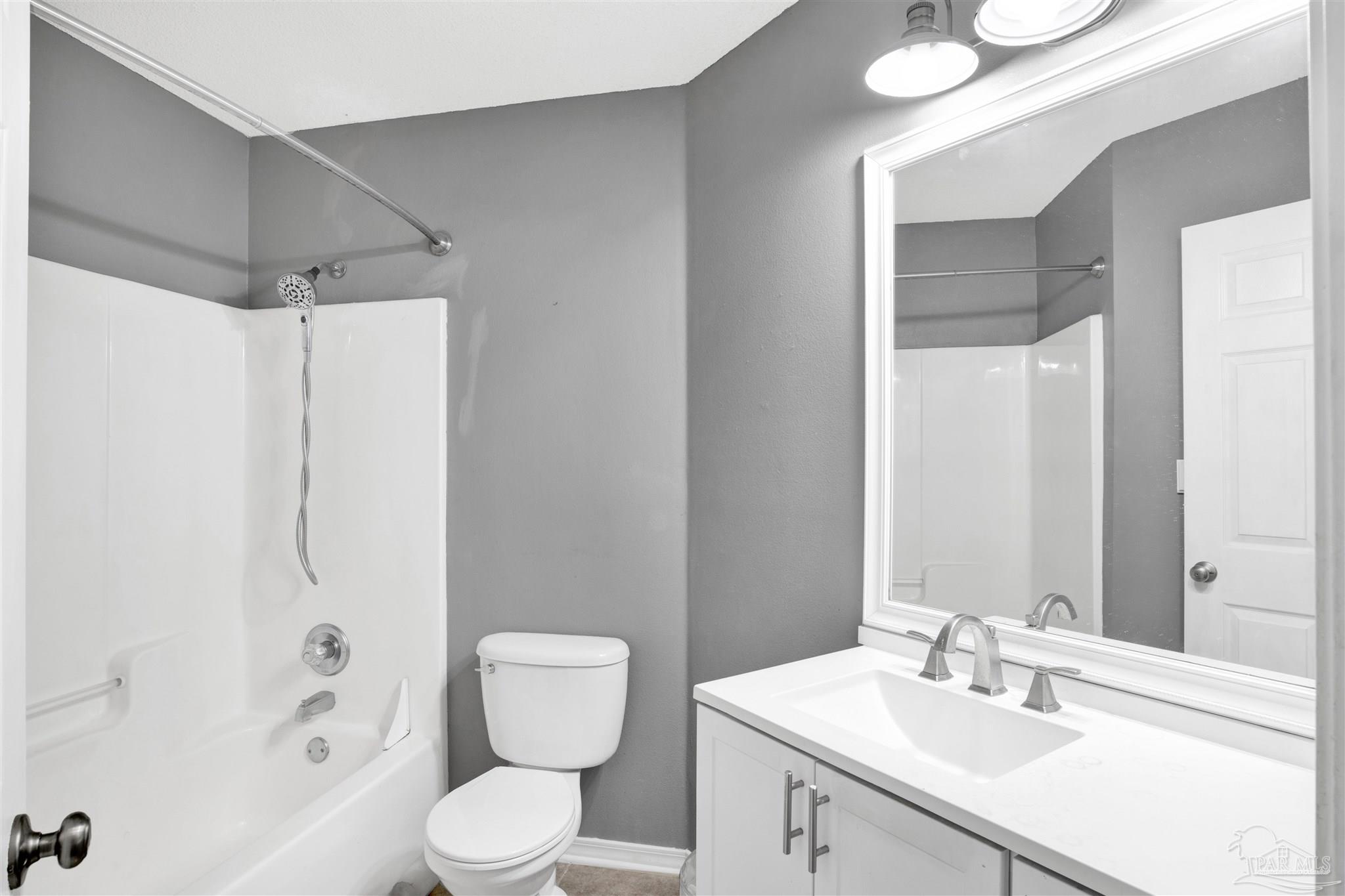 7604 Brewster Street Navarre, FL 32566 - Photo 27 of 36 a bathroom with a sink toilet and shower