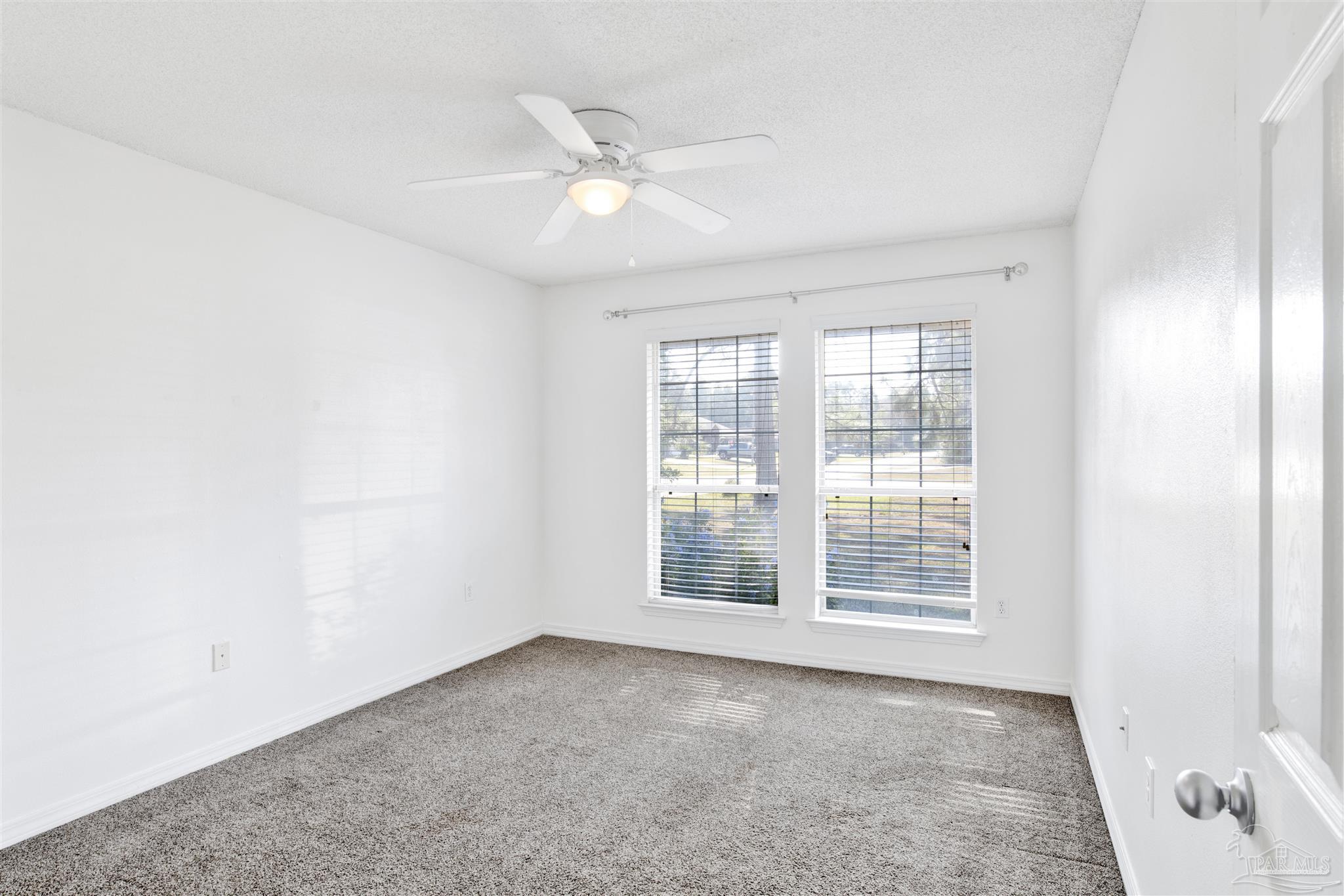 7604 Brewster Street Navarre, FL 32566 - Photo 30 of 36 an empty room with windows and fan