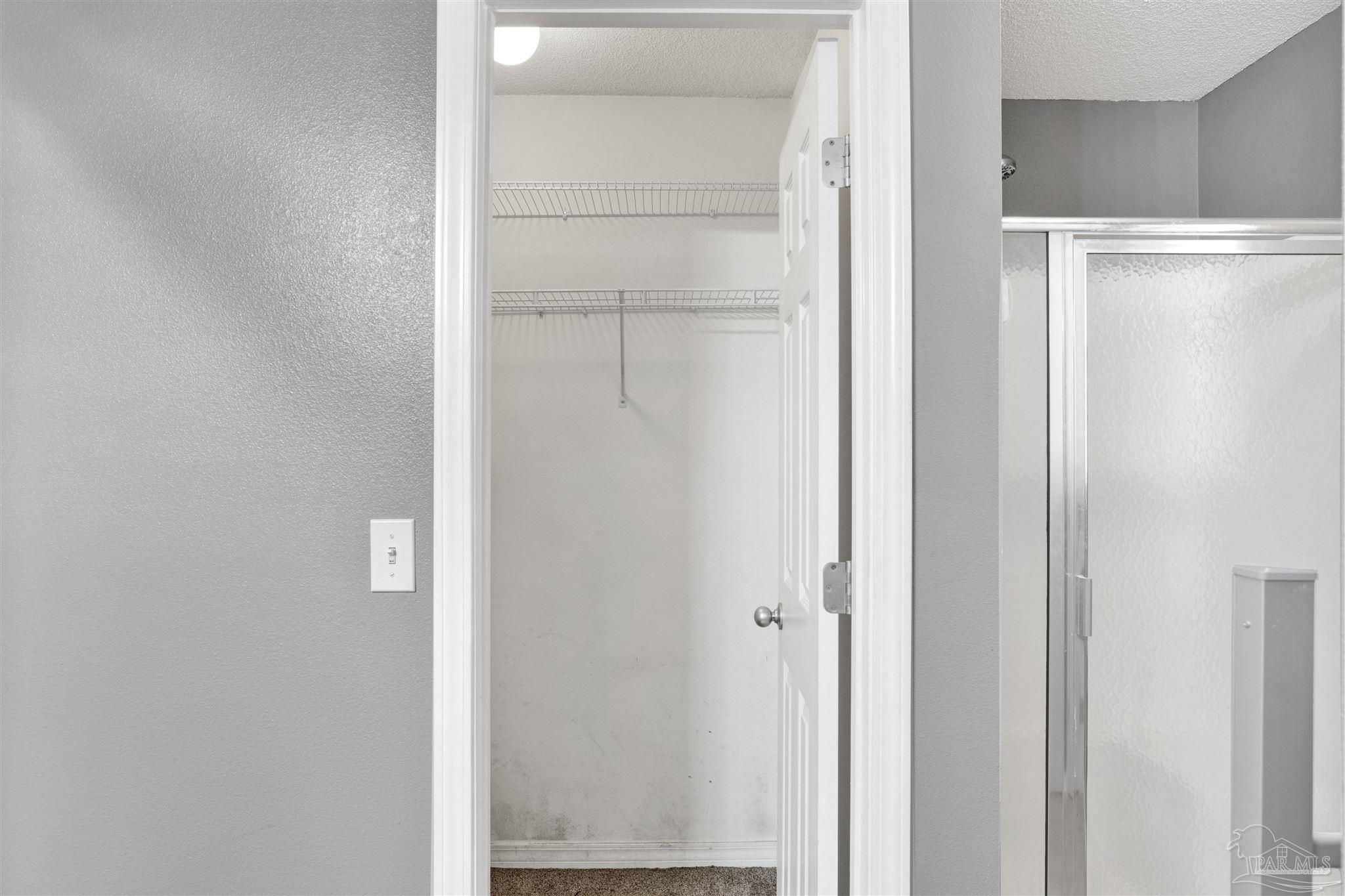 7604 Brewster Street Navarre, FL 32566 - Photo 35 of 36 a view of walk in closet with empty racks