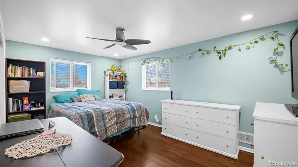 a bedroom with a bed and a book shelf
