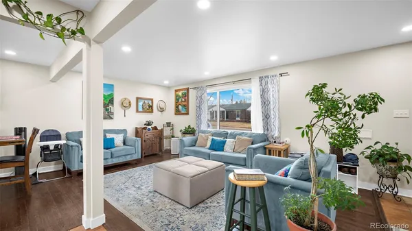 a living room with furniture and a potted plant