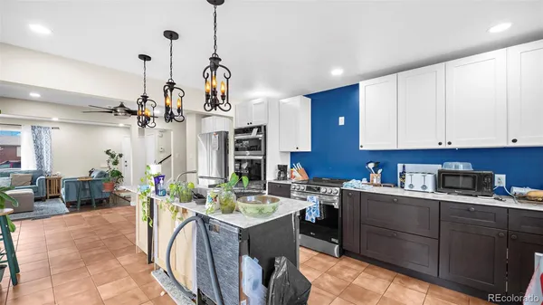 a kitchen with a sink a counter space appliances and cabinets