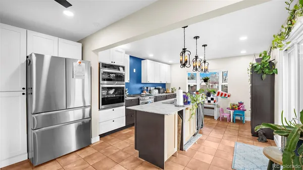 a kitchen with a refrigerator and a sink