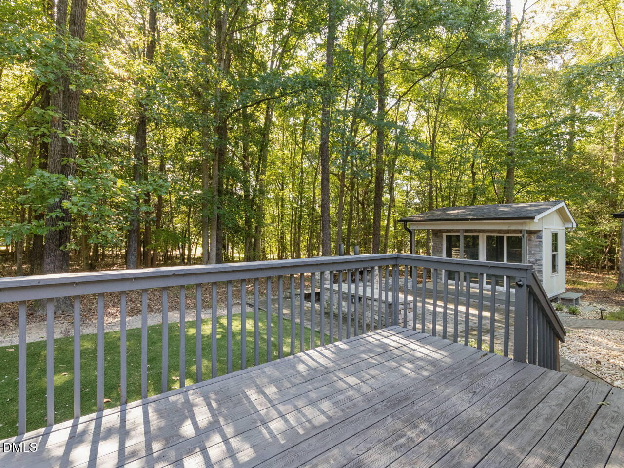 4100 Timberbrook Drive Raleigh, NC 27616 - Photo 24 of 36 Large deck overlooking the outdoor entertainment space. Terrace with stone fireplace. He/She shed with front porch for a perfect hideaway, office, or play space.