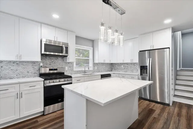a kitchen with a stove a sink and a refrigerator