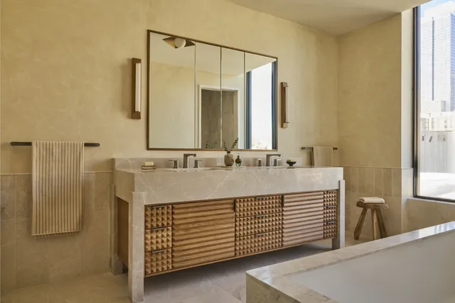 a bathroom with a double vanity sink and a mirror